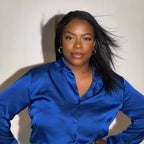 Beautiful African American woman with wearing natural makeup showcasing her long natural hair blowing in the wind