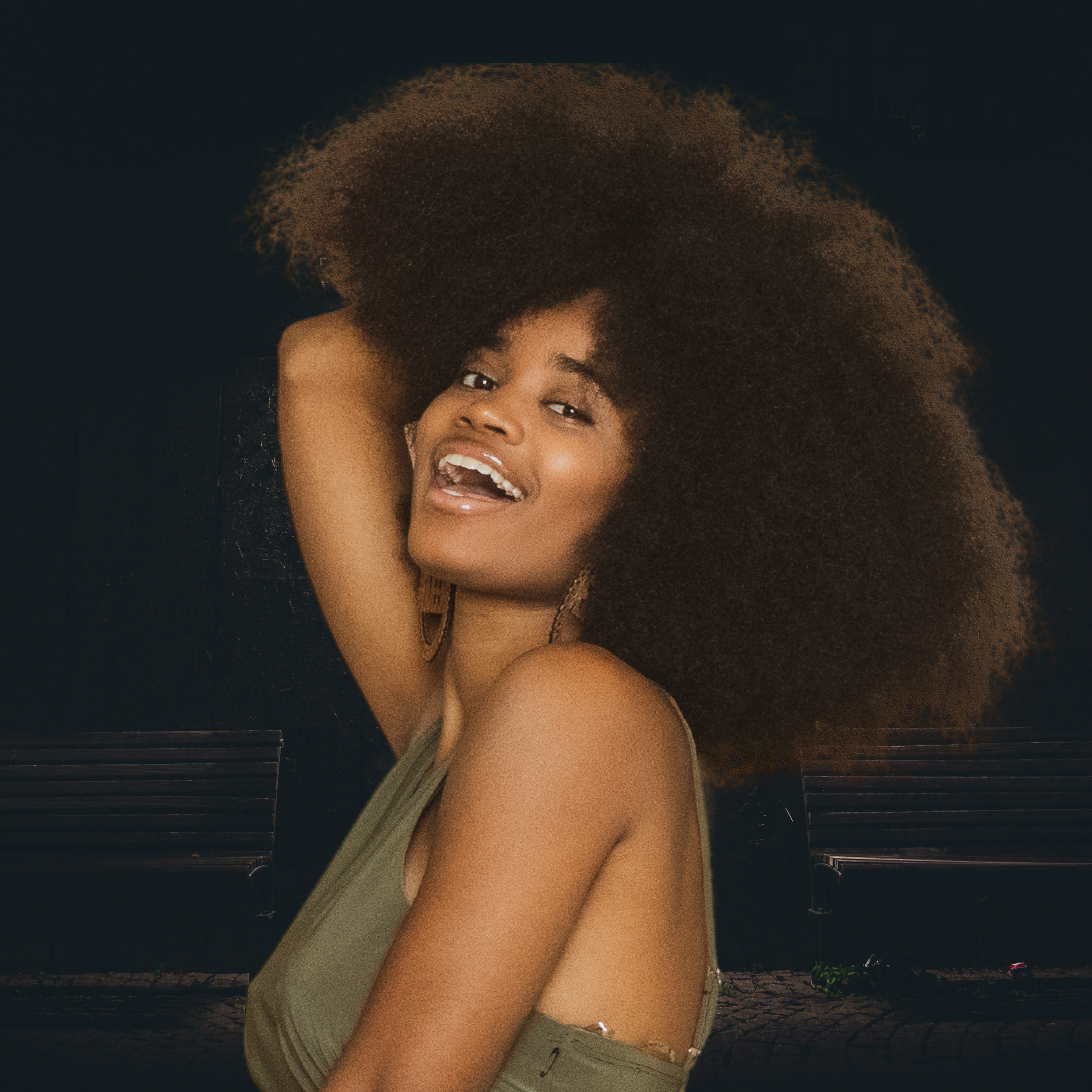 afican american woman with big bold beautiful afro  showcaseing her health hair 