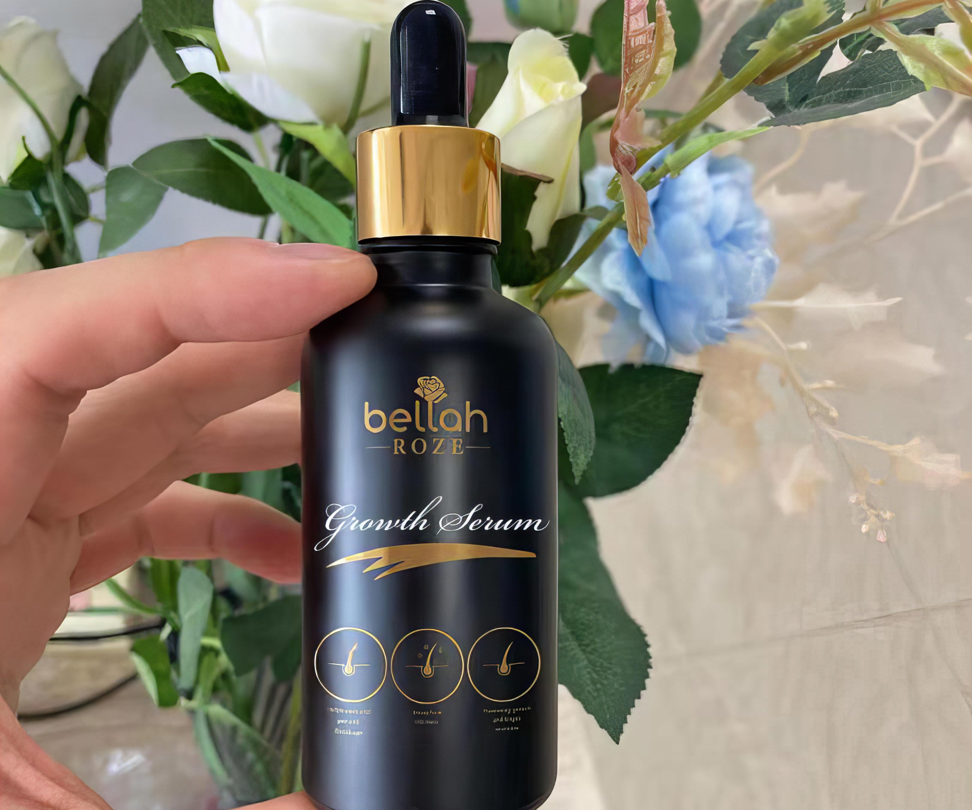 Hand hold hair growth oil in luxury black and gold packaging 